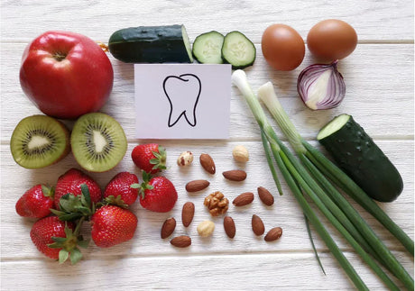 Fresh fruits, vegetables, nuts, and eggs with tooth drawing, healthy food for dental care
