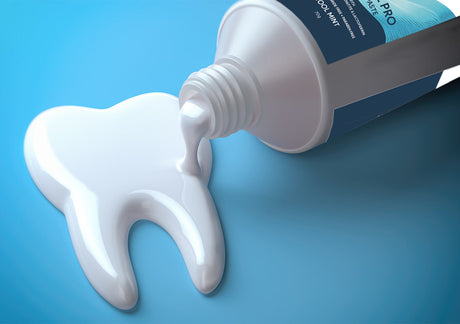 Toothpaste squeezed from a tube in the shape of a tooth on a blue background